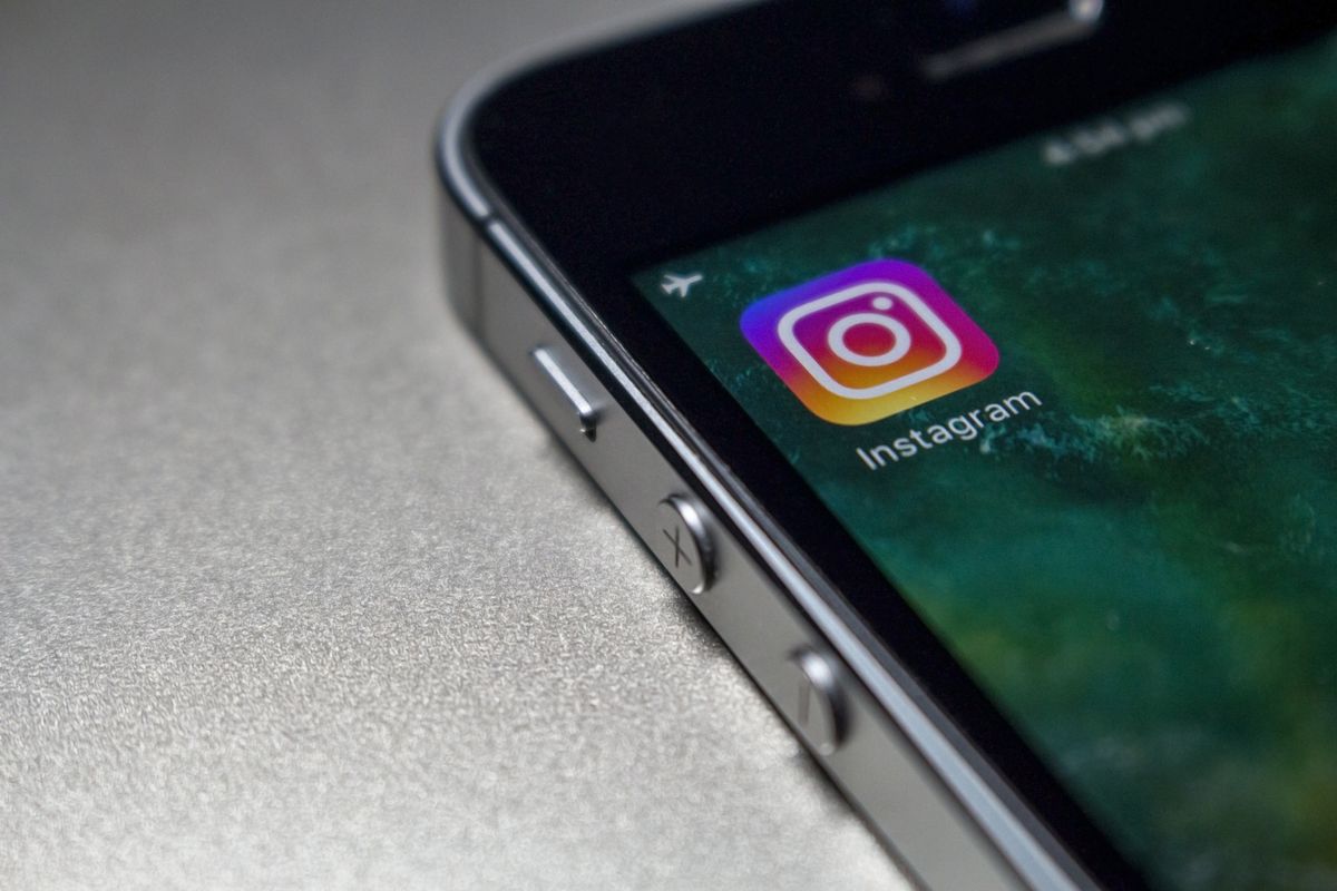 Close-up of a smartphone screen showing the Instagram app, representing AI Instagram caption generator tools