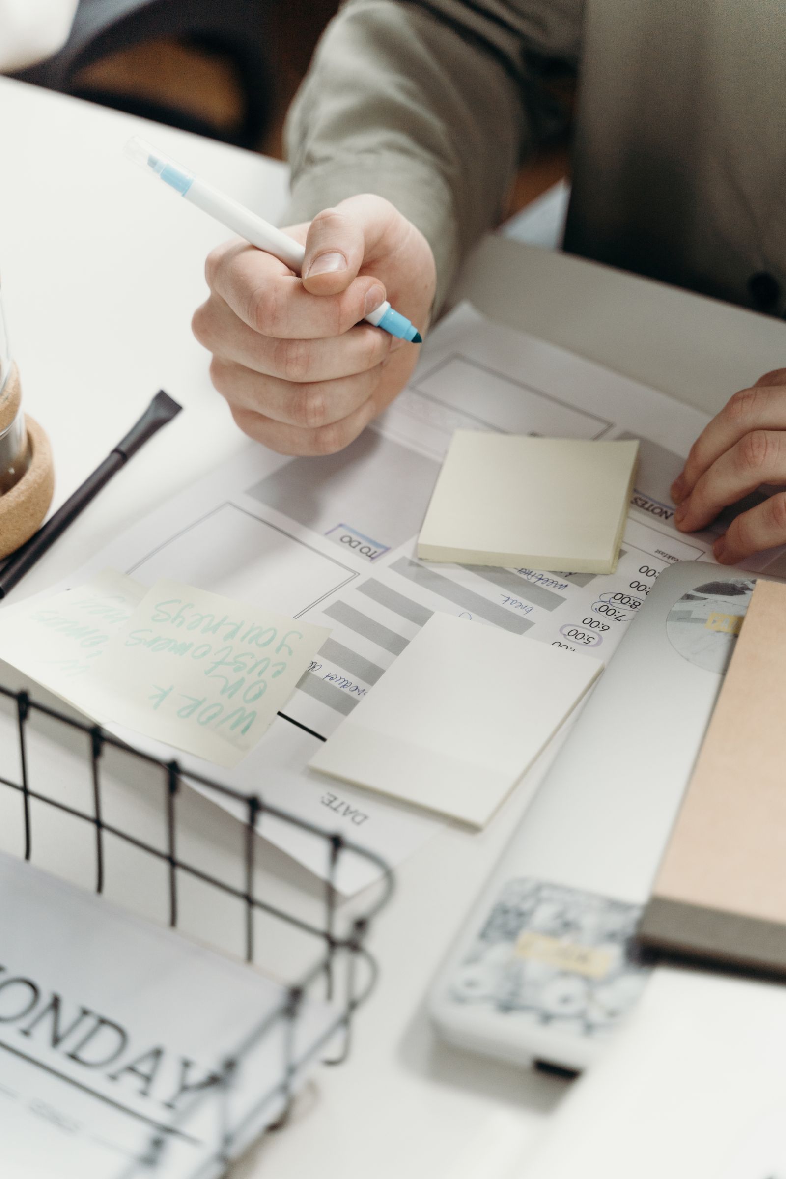 Marketer organizing a content calendar with sticky notes while planning automated social media posts