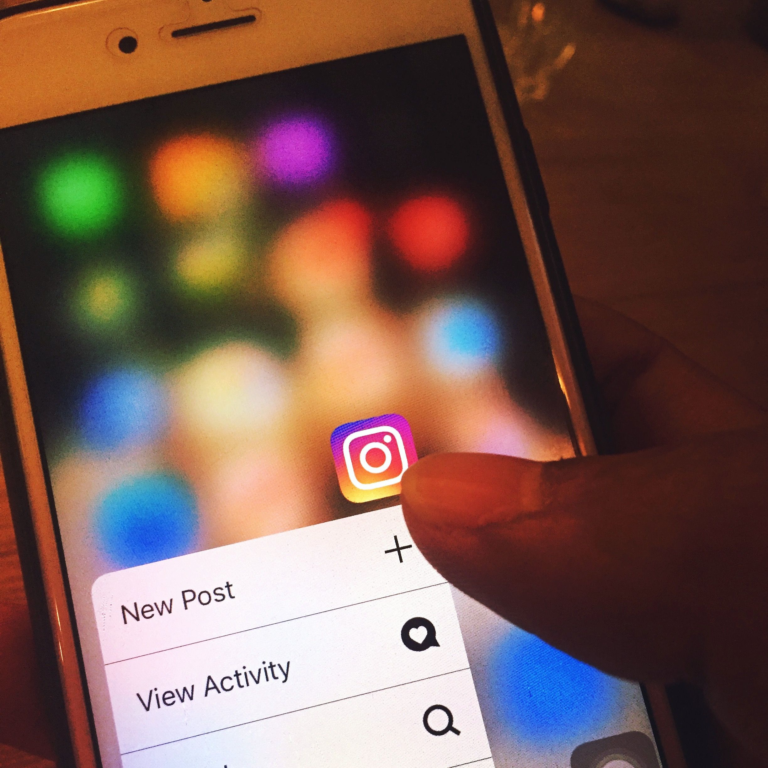 Person opening Instagram on a phone, where comment to DM automation delivers links automatically