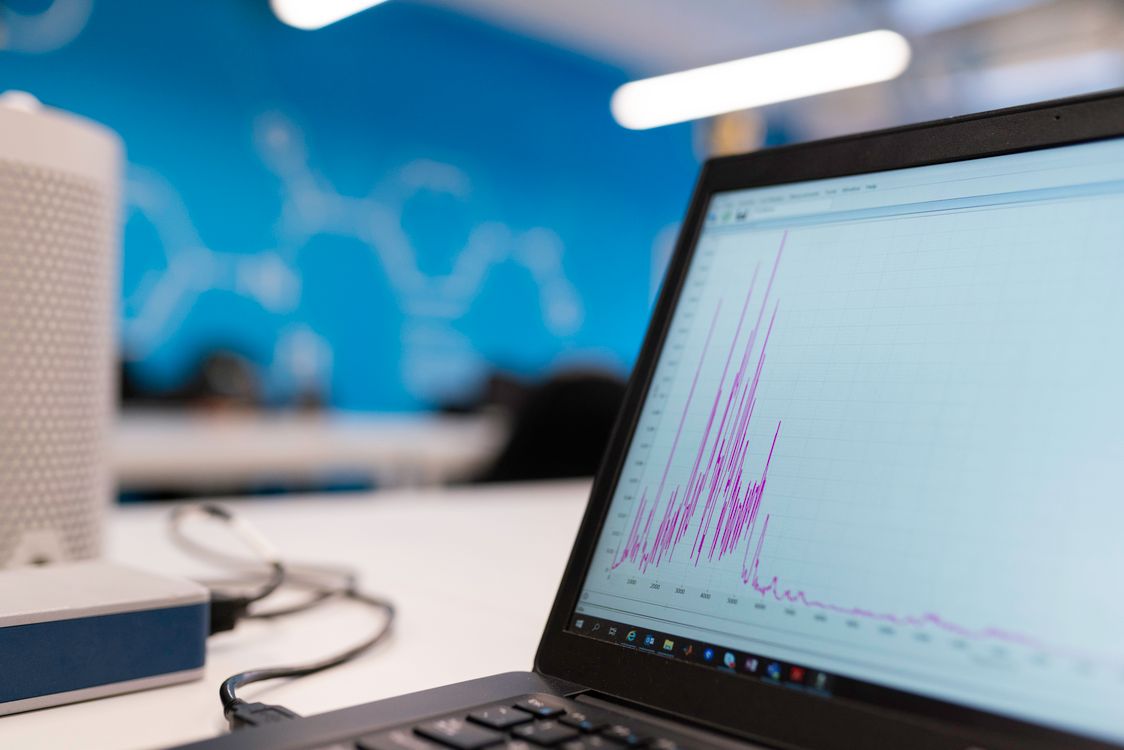 Laptop showing a social media analytics dashboard with a line graph trending upward