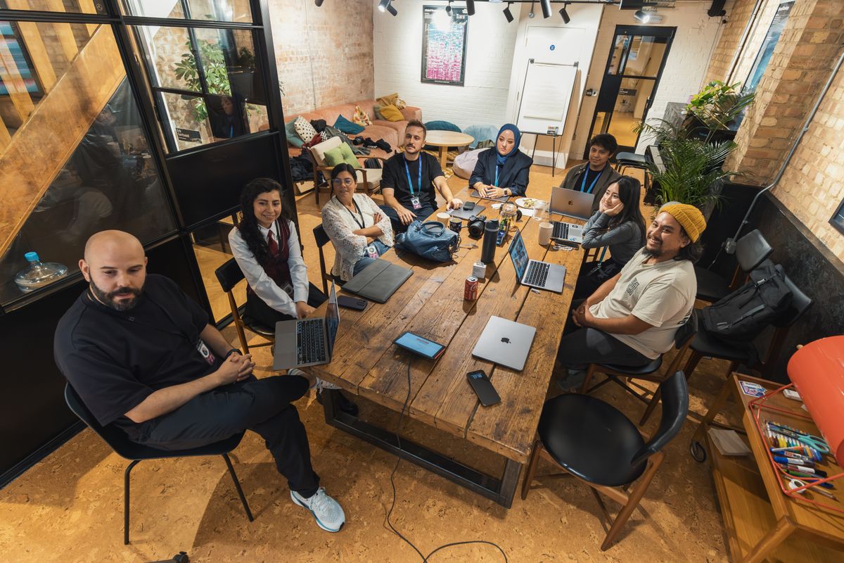 Social media team using collaboration tools on laptops in a modern workspace