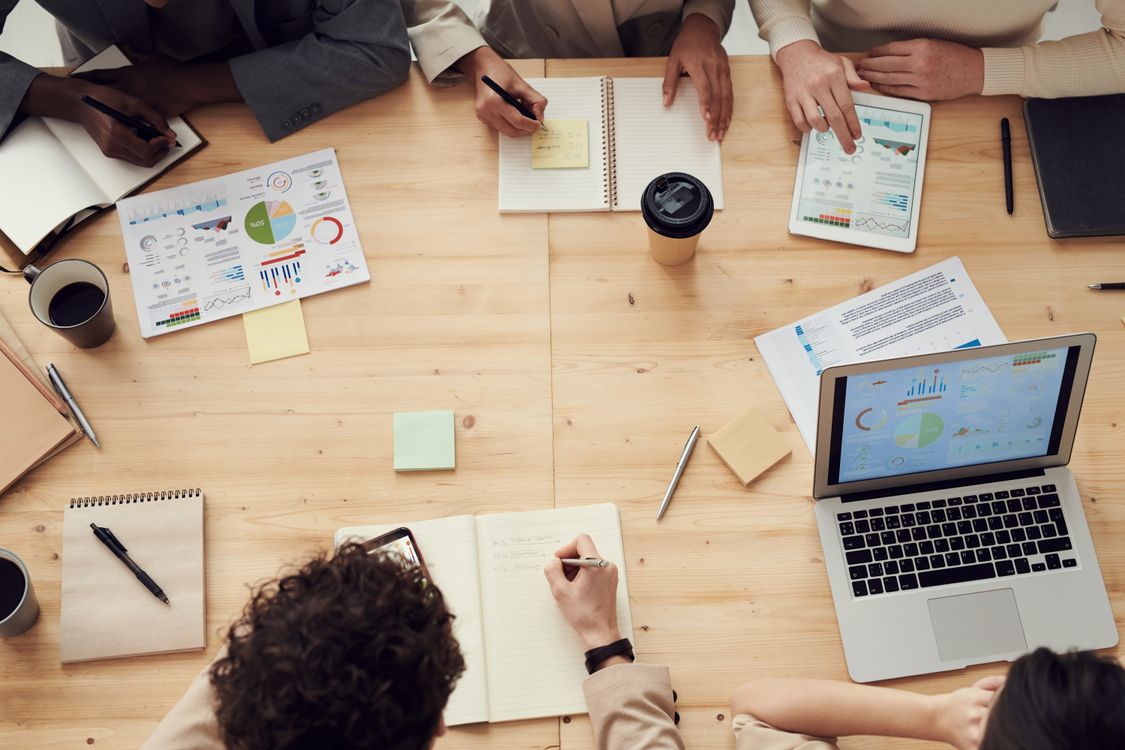Freelance social media manager presenting social media management packages to a client team in a meeting